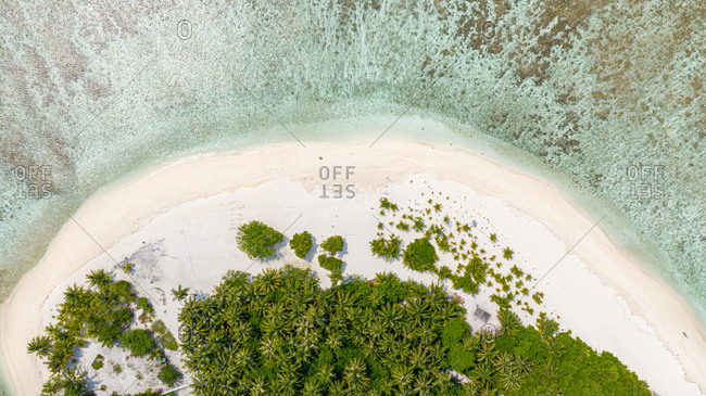 Aerial view of local island Omadhoo, located in Alif Dhaal Atoll, Maldives, Indian Ocean with reef, local beach and sandbank