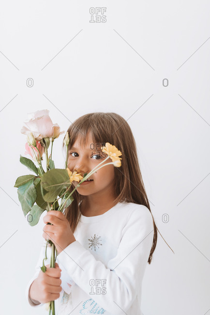 Young girl holding a variety of spring flowers