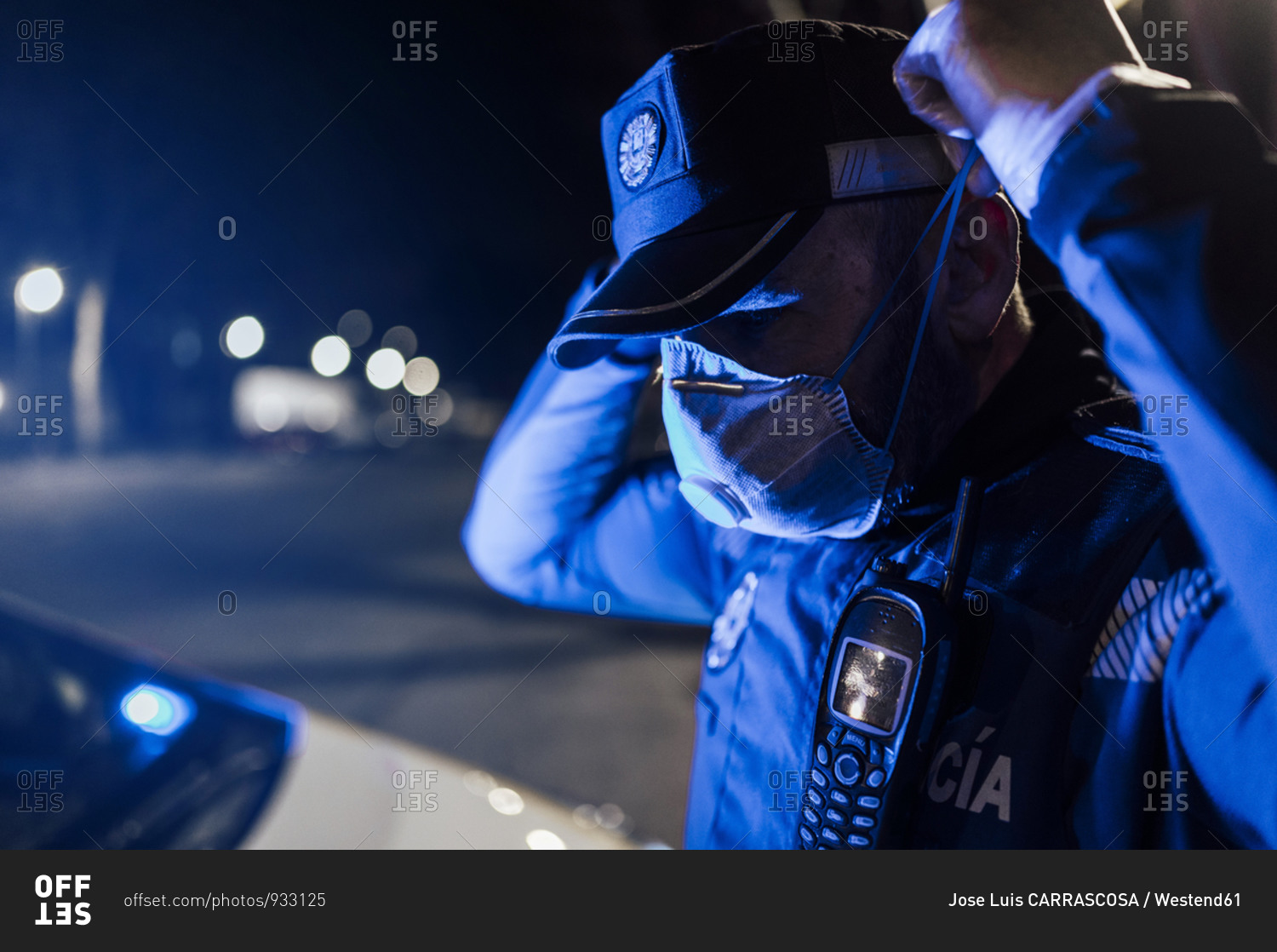 Portrait of policeman wearing mask and protective gloves at night stock ...