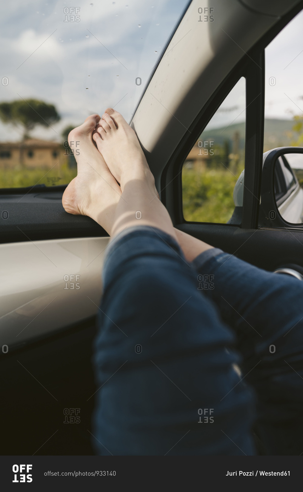 Woman's bare feet in a car stock photo - OFFSET