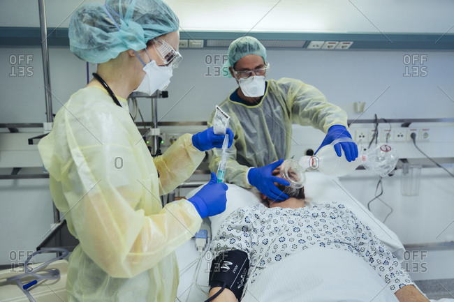 Doctors caring for patient in emergency care unit of a hospital