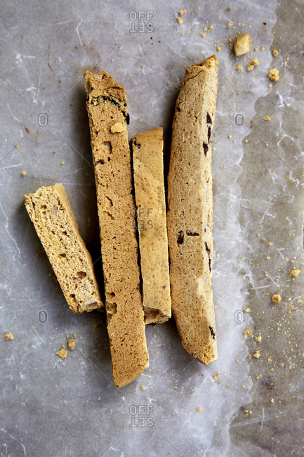 Freshly baked biscotti on wax paper and baking tray