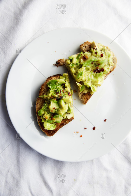 Avo Toast on a white plate and white linen