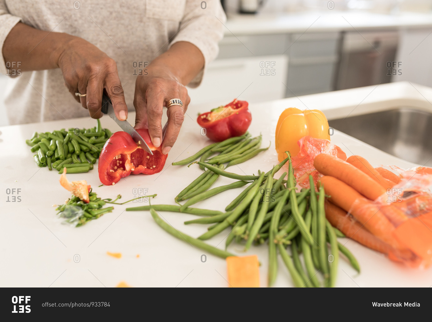 Close up mid section of a senior African American woman spending time at home, social distancing and self isolation in quarantine lockdown during coronavirus covid 19 epidemic, chopping vegetables on a chopping board