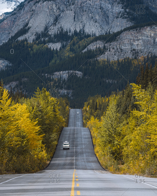 Campervan driving through Icefields Parkway in fall, Alberta, Canada