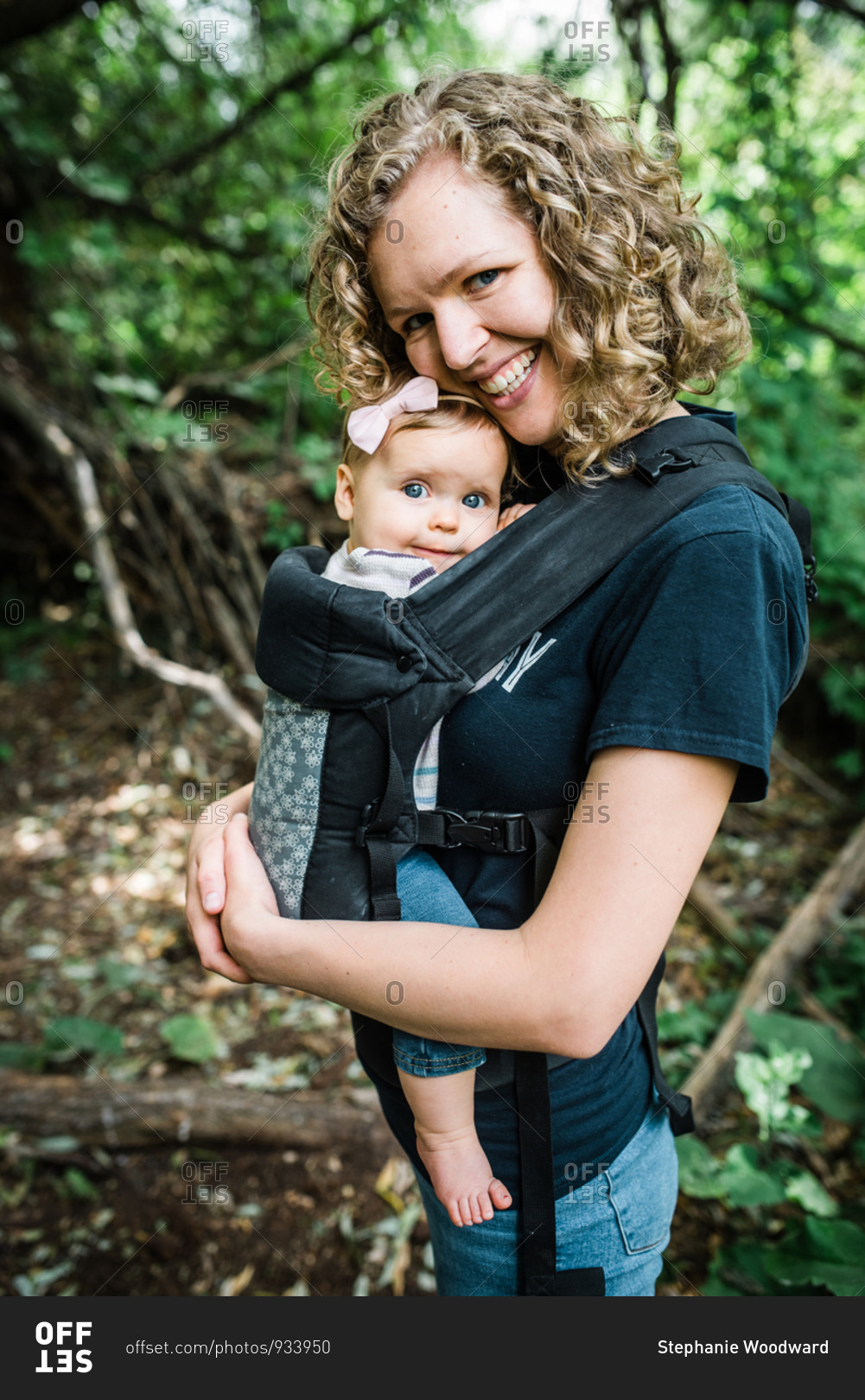 Portrait of mom carrying baby girl while hiking