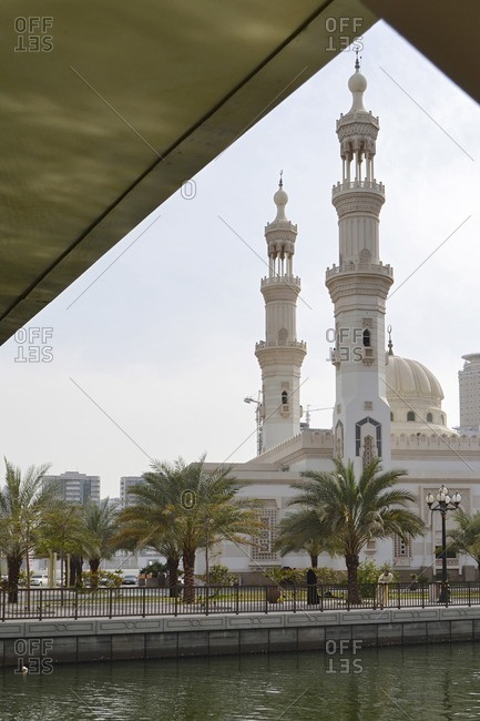 February 13, 2012: Al Qasba Mosque in front of residential skyscrapers, contrast, AL QASBA quarter, Emirate of Sharjah, United Arab Emirates, Arabian Peninsula, Middle East