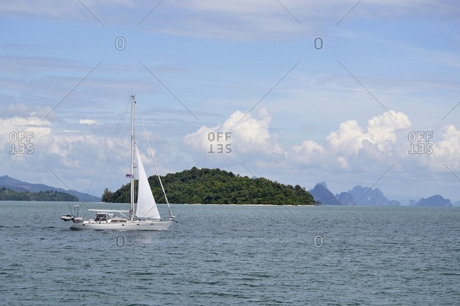November 29, 2011: Sailing boat in front of islands in the bay of Pang Nga, southern Thailand, Southeast Asia