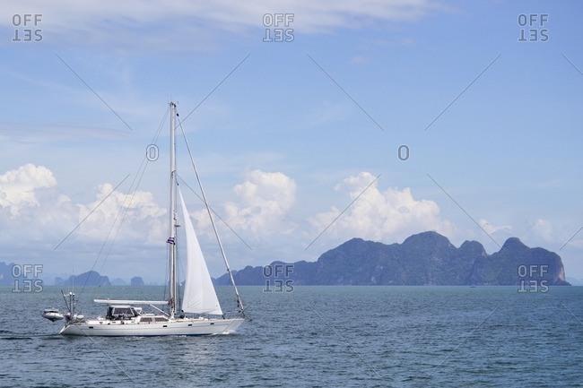 November 29, 2011: Sailing boat in front of islands in the bay of Pang Nga, southern Thailand, Southeast Asia