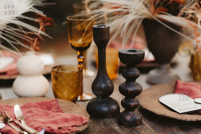 Close up of rustic table set with fall decorations outdoors