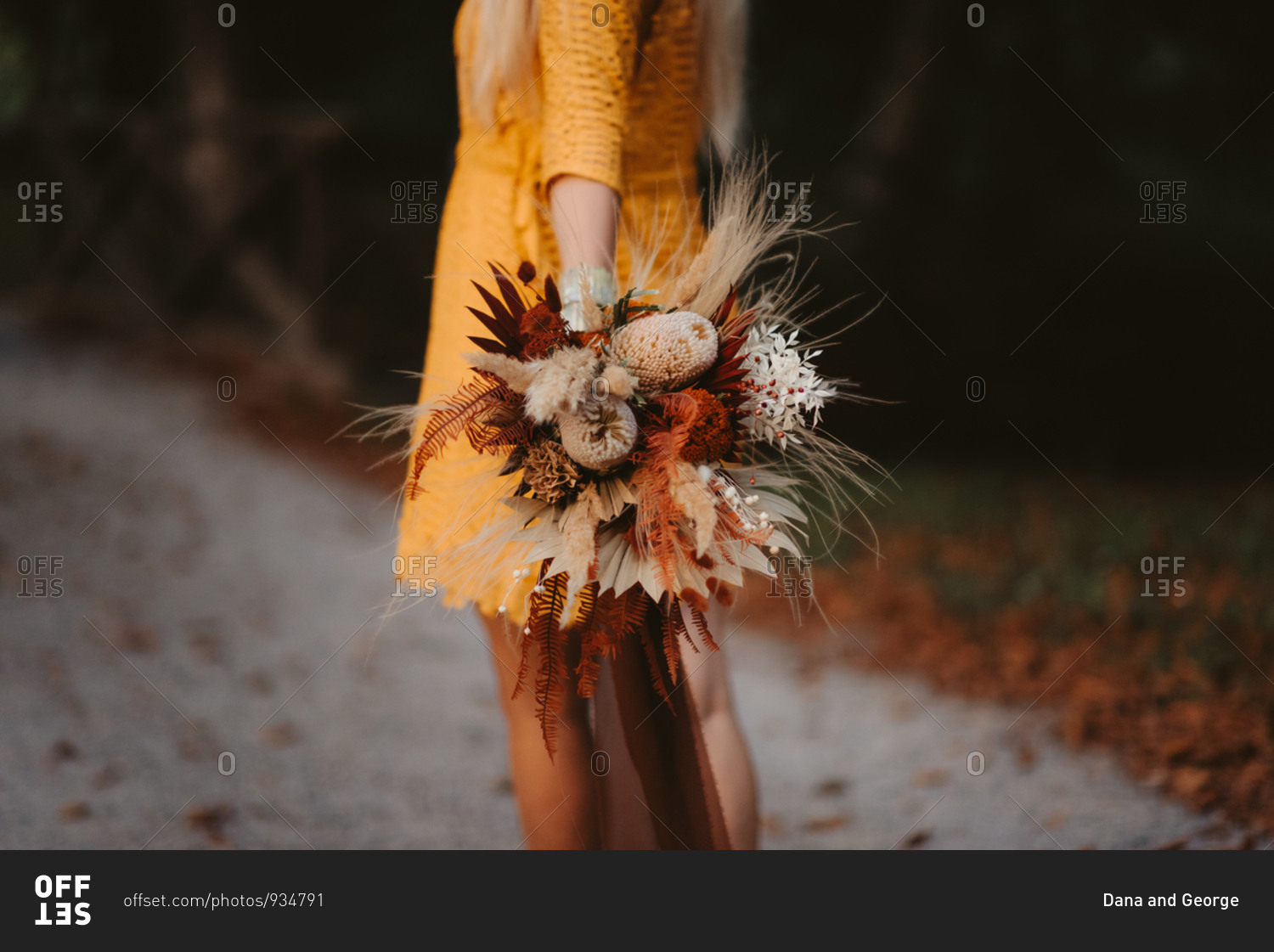 Bride wearing a yellow dress and holding fall wedding bouquet