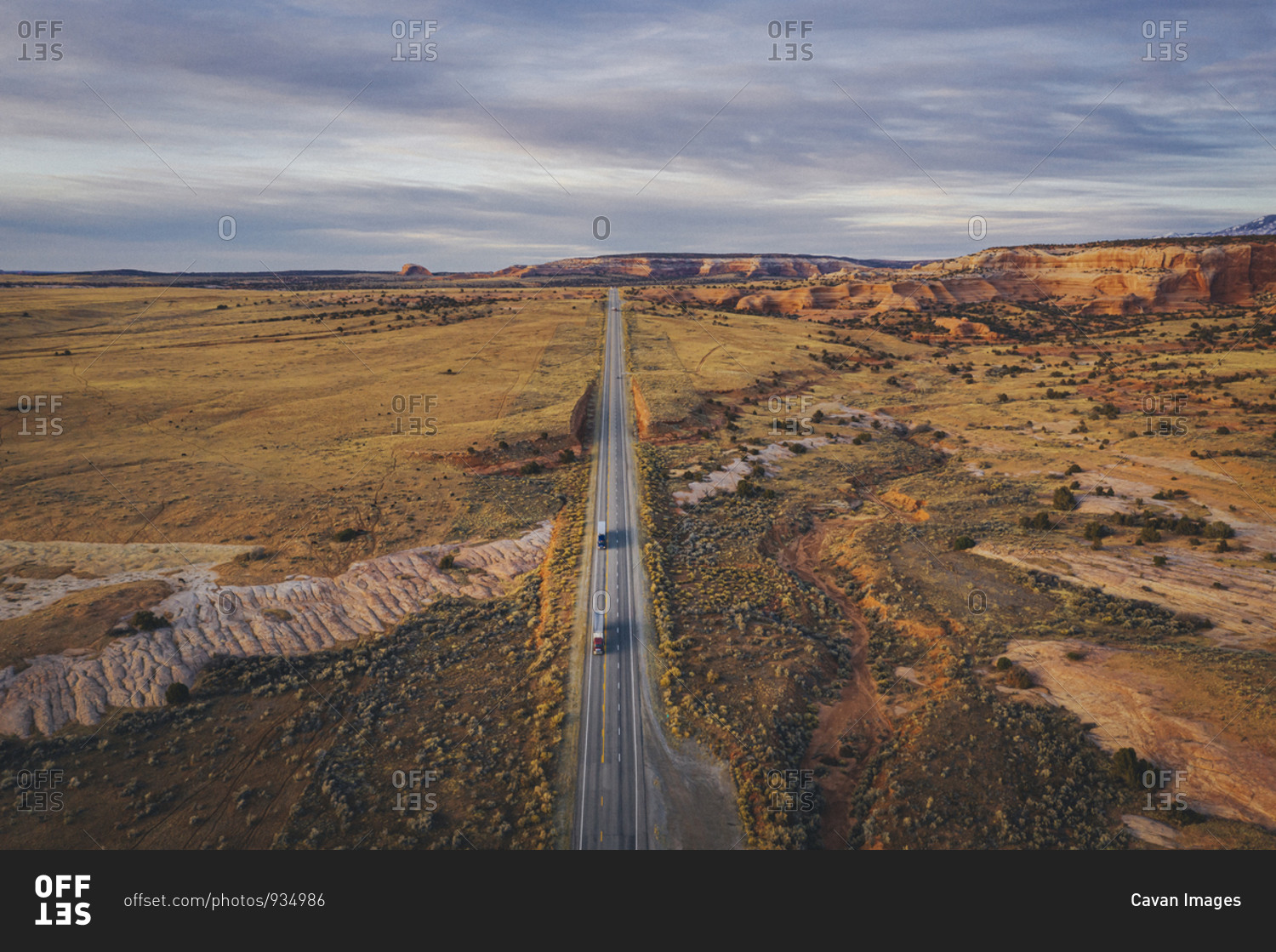 Lonely Utah\'s road in the evening with trucks from above
