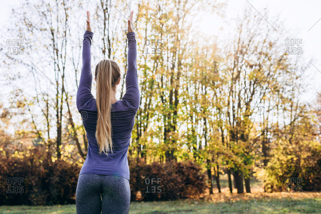 Woman in the forest Back view Outdoor activity Young attractive woman doing exercise working outdoors. Rear view