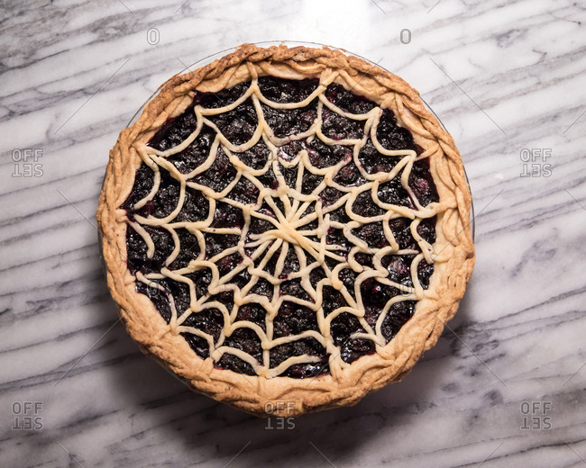 Blueberry Pie with Spiderweb Lattice Crust on Marble Pastry Board