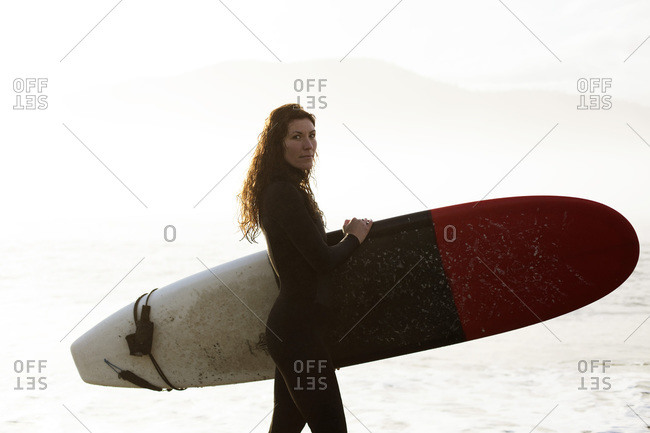 Beautiful, fit surfer girl in the Pacific Northwest