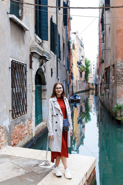 Young tourist in dress and coat on the streets of Venice