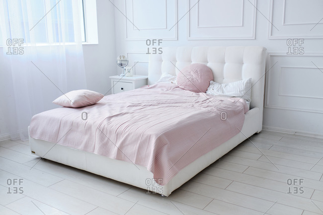 A large double bed in a bright room
