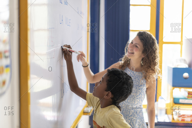 child writing on whiteboard