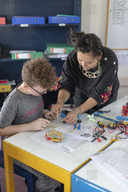 Kathmandu, Nepal - March 4, 2019: Close up of a teacher in a school in Kathmandu helps students with their work in a science and technology class