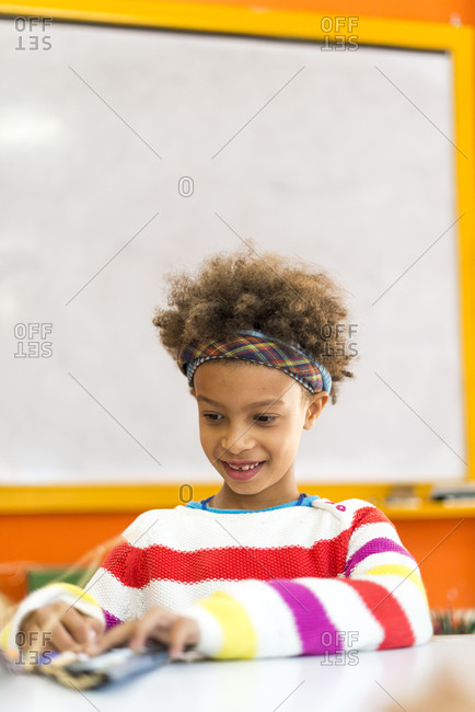 Kathmandu, Nepal - December 12, 2015: A girl makes a Christmas decoration at a school in Kathmandu