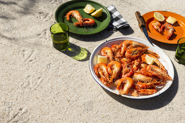 Cooked shrimp on plates in beachy setting with copyspace