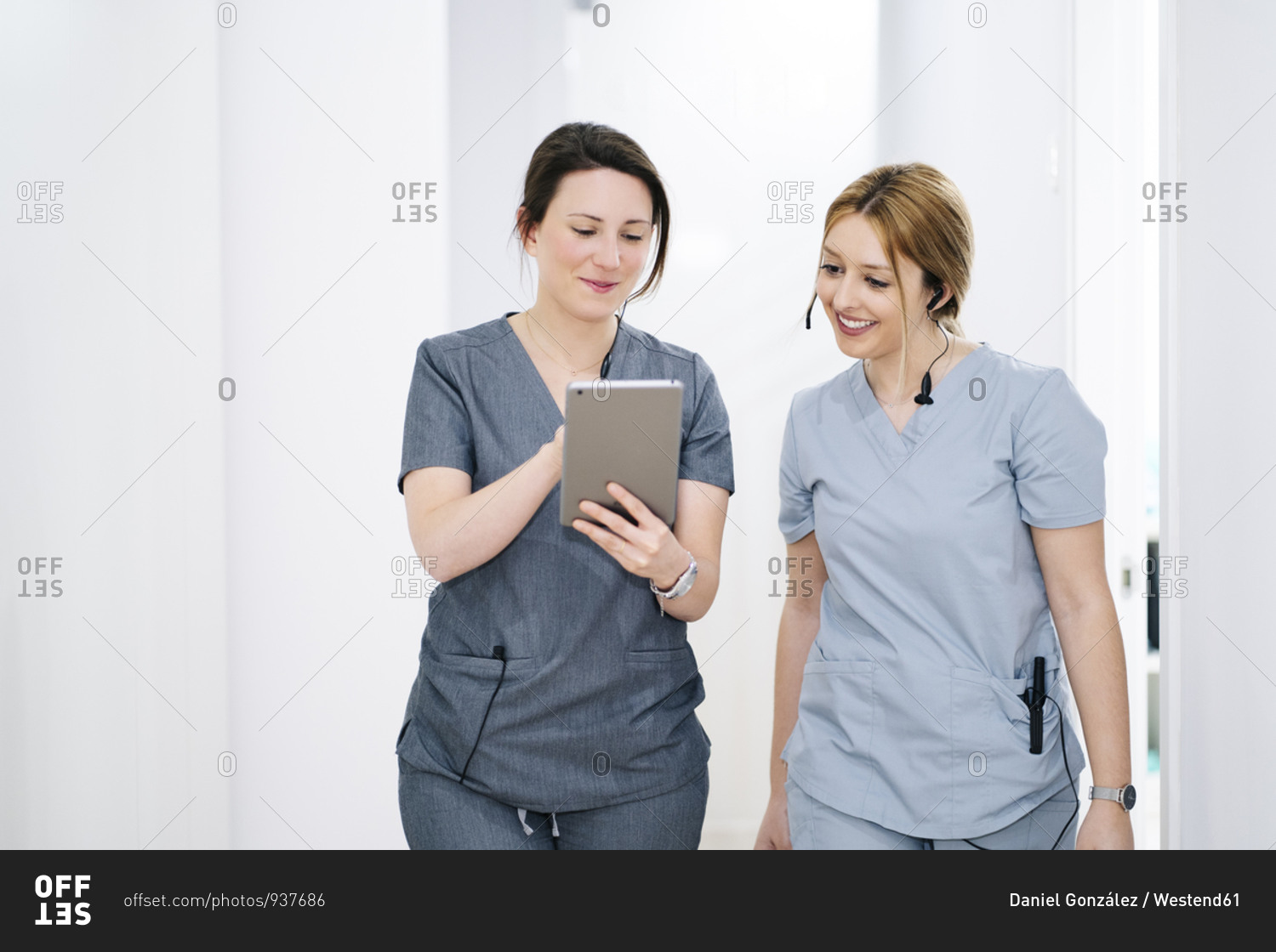 Two medical secretaries with headset and tablet in medical practice