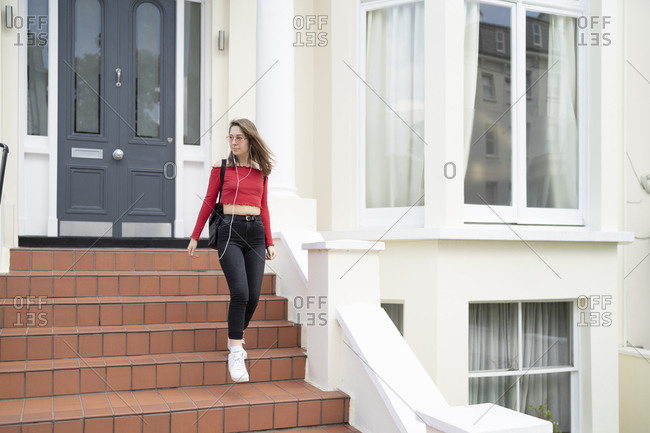 Young woman walking down stoop
