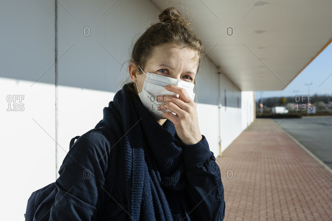 Portrait of woman wearing mask at an empty street