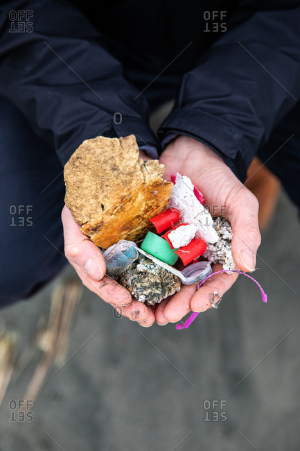 Close up of man holding handful of collected trash