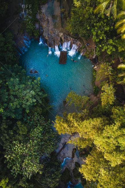 Aerial view of Cambugahay Falls surrounded by trees in Tigbawan, Lazi, Siquijor, Philippines