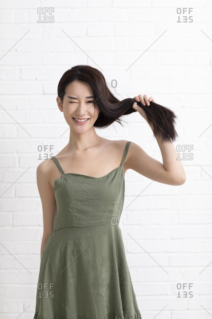 Beautiful young Chinese woman wearing a green summer dress