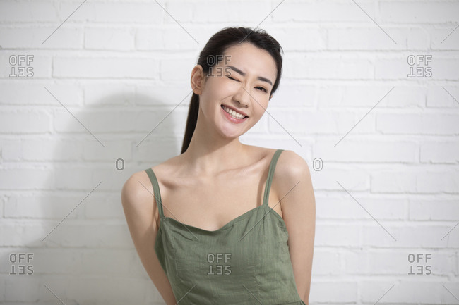 Beautiful young Chinese woman wearing a green summer dress