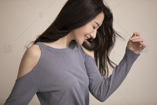 Woman poses near a window wearing purple sweater and panties stock photo -  OFFSET