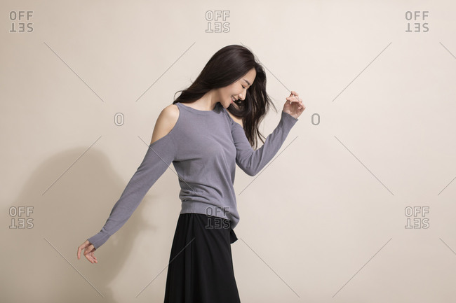 Woman poses near a window wearing purple sweater and panties stock photo -  OFFSET