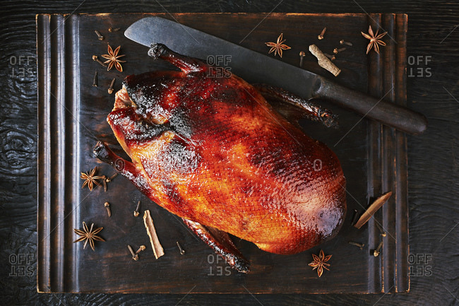 Still life with peking duck on cutting board, overhead view