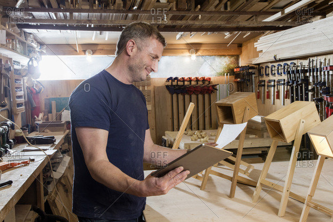 Designer using digital tablet by prototypes of table lamps