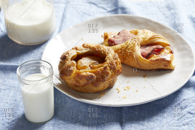 Breakfast pastries with glass of milk on table