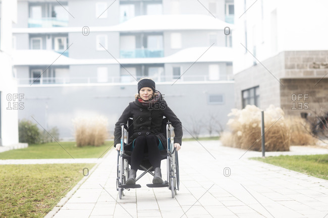 Woman in wheelchair in residential area