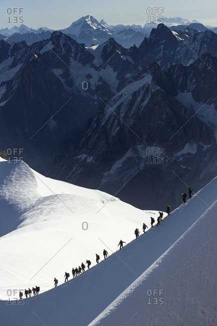 Mountain climbers on descent in distance, Chamonix, Rhone-Alps, France