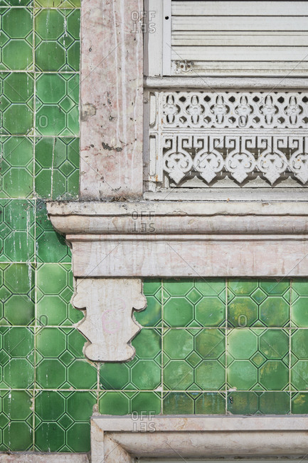Detail of a window surrounded by green decorative tile, Lisbon, Portugal