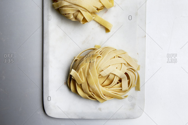 Fresh, raw homemade pasta on a kitchen countertop shot from above,