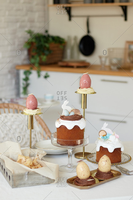 dessert sweets for chocolate eggs, Easter cake with rabbit, crunchy cookies angel wings
