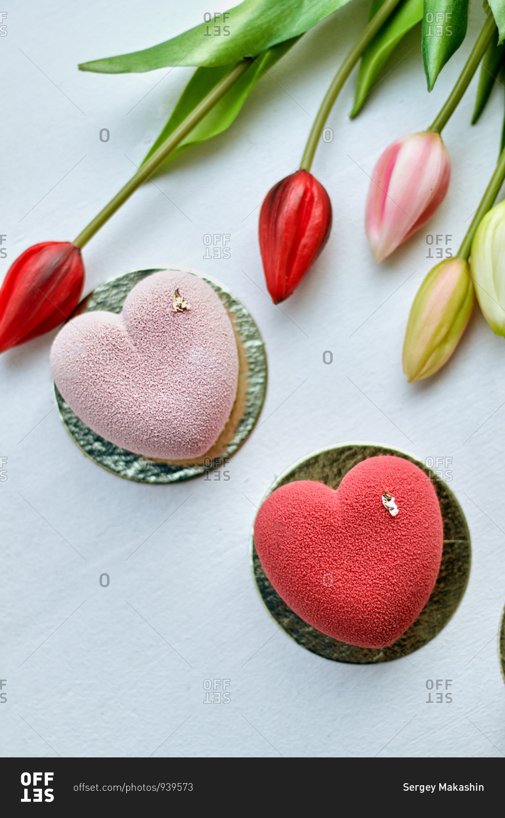 women's day Valentine mousse cake in the form of a heart
with a matte surface and tulips stock photo - OFFSET