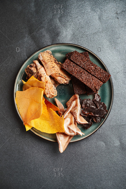 beer snacks in a pub restaurant, black bread croutons, pork ears, chips, grilled chicken, liver sausage