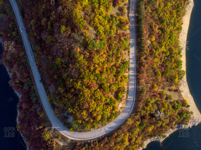 Road in the autumn forest aerial view.