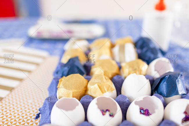 Close-up multi color confetti and eggshells over cloth table
