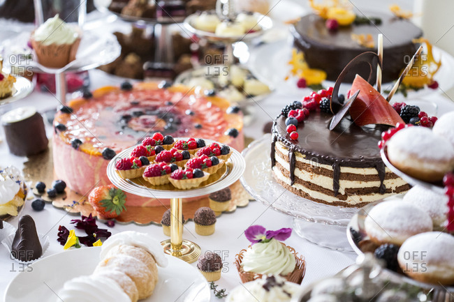 Dining table filled with all kinds of snacks and desserts