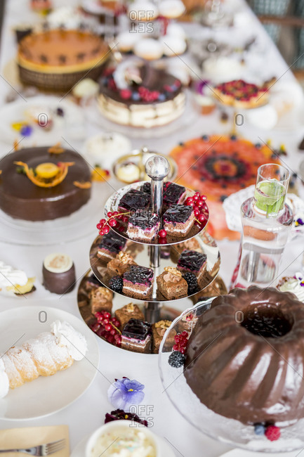 Dining table filled with all kinds of snacks and desserts