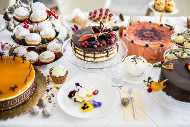 Dining table filled with all kinds of snacks and desserts