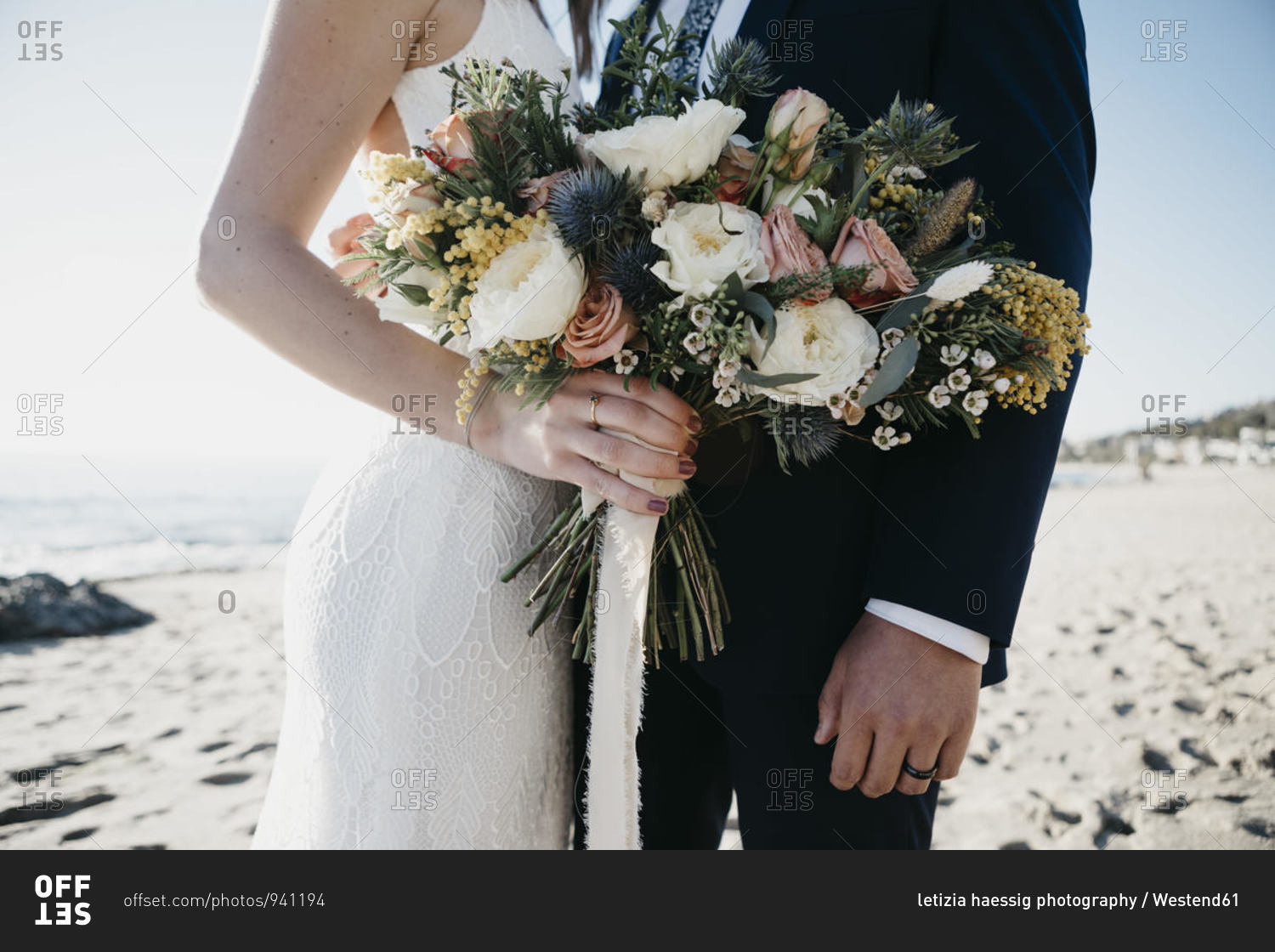 Bridal couple with bridal bouquet at the beach